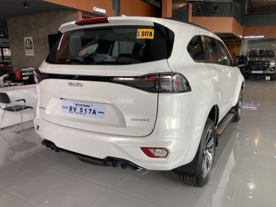 Rear and side view of a white SUV with sleek taillights and AWD badge