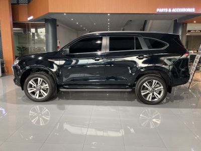 Side profile of a black SUV with tinted windows and alloy wheels