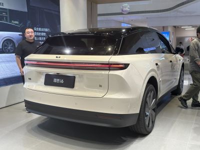 Rear view with continuous LED tail light strip and sleek SUV design