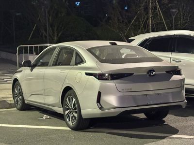 Sleek aerodynamic rear with continuous dark tinted rear lights and alloy wheels.