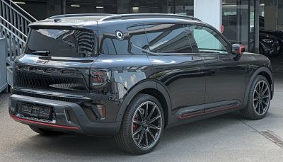 Rear-side view of a sleek crossover SUV with tinted windows and sporty wheels