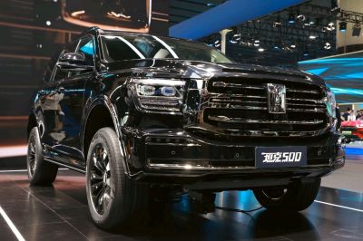 Front grille and LED headlights of a black mid-size SUV