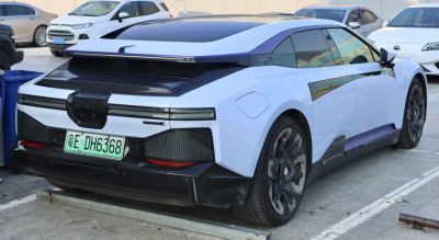 Futuristic electric coupe rear design with sleek tail lights and aerodynamic styling