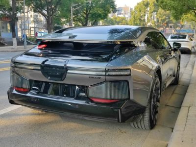 Rear view of futuristic electric sedan with LED taillights and aerodynamic design