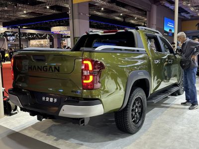 Pickup truck rear with illuminated taillight and rugged tires