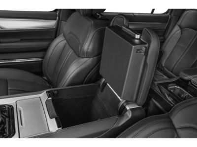 Open center console storage and premium leather seats in luxury SUV interior