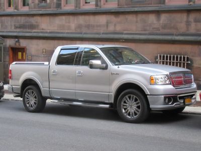 Luxury silver pickup with chrome grille and alloy wheels