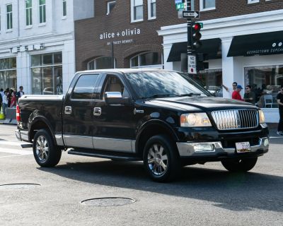 Crew cab pickup with chrome grille and wheels