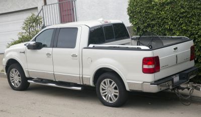 Side view of a luxury pickup with crew cab and chrome trim