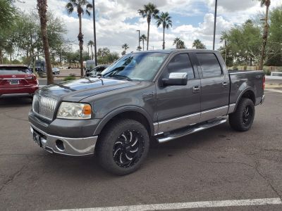 Gray full-size luxury pickup with chrome trim and custom black wheels