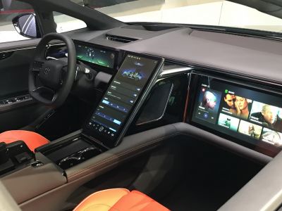 Triple digital screens interior with sleek dashboard and red seats