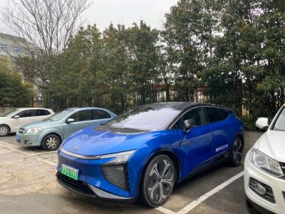 Blue electric SUV with sleek front and LED lights