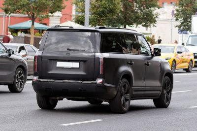 Matte black large SUV rear with vertical tail lights and tinted windows