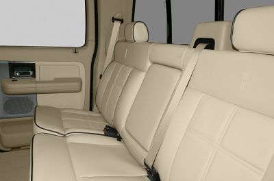 Beige leather rear seats with headrests and seat belts