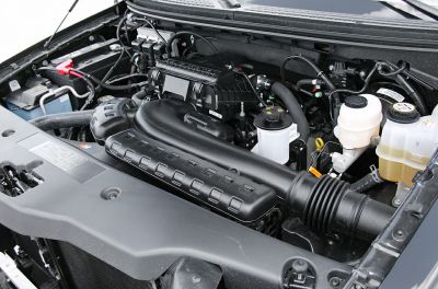 Intake system and fluid reservoirs inside a vehicle engine bay