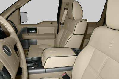 Beige leather seats with detailed stitching and padded armrest console