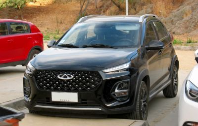 Front view of a black crossover SUV with diamond-pattern grille and split headlights.