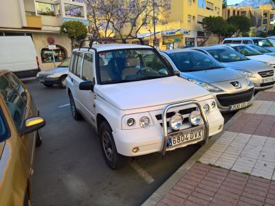 White SUV with front bull bar and dual off-road lights