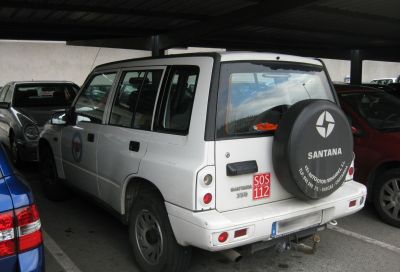 Rear view of an SUV with spare tire cover and SOS emergency sign