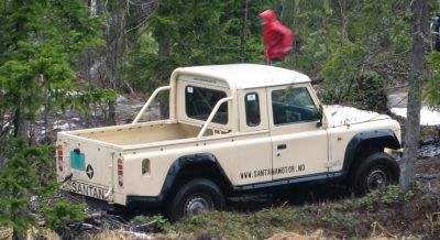 Beige pick-up with off-road tires and protective fenders