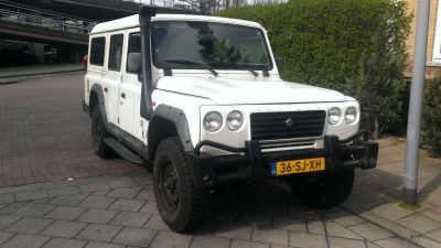 Off-road SUV with snorkel, round headlights, and bull bar