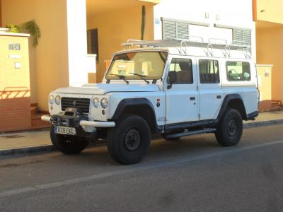 White 4x4 SUV with roof rack and offroad features