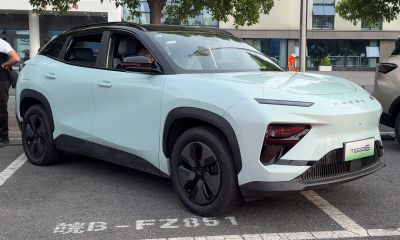 Front side view of SUV with slim headlights and sculpted body panels
