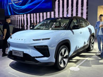 Futuristic electric SUV front with LED headlights and aerodynamic wheels.