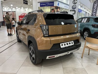 Rear view of a modern compact vehicle with distinctive tail lights and embossed rear nameplate.