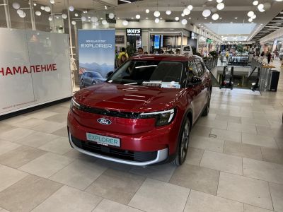Red all-electric SUV front and side view indoors