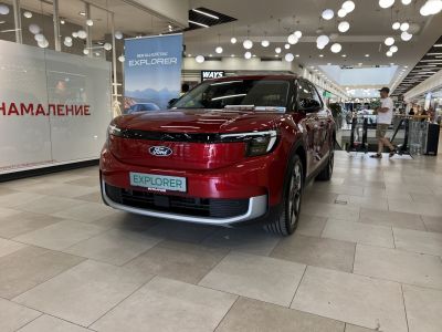 Front view of a sleek modern electric SUV displayed indoors.