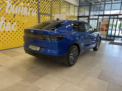 Sleek blue electric vehicle rear and side view in showroom.