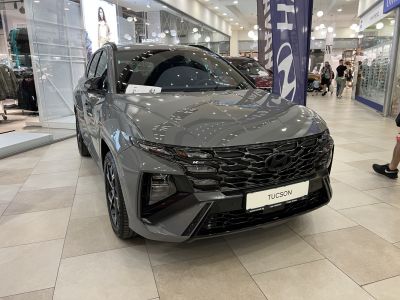 Modern SUV front with black hexagonal grille and split LED headlights.
