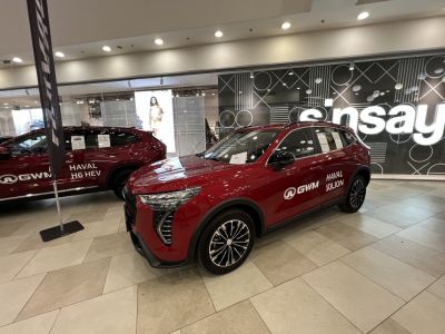 Red SUV with distinct LED headlights and sporty alloy wheels