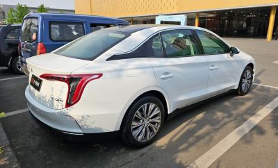 Rear and side view of a sleek modern sedan with unique tail lights