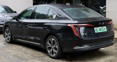 Rear and side view of black sedan with unique taillights and alloy wheels