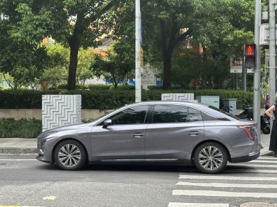 Side view of a sleek sedan with aerodynamic body and futuristic tail lights