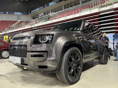 Front view of an SUV with black alloy wheels and bold grille