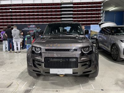 Close-up of SUV front with grille and headlights