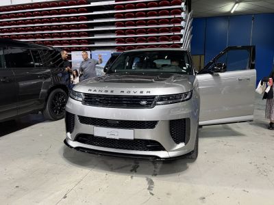 Front view of a modern SUV with sleek grille and open door