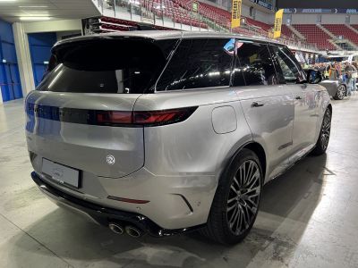 Rear and side view of silver luxury SUV with quad exhaust and sleek design