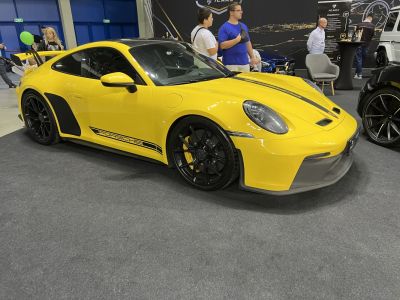 Yellow sports coupe with black racing decals and large rear spoiler