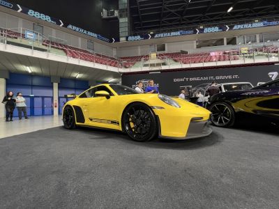Yellow sports coupe with aerodynamic kit and black alloy wheels