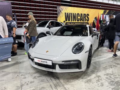 Front view of white sports coupe with round headlights