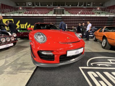 Red Porsche 911 (997) front with round headlamps and aerodynamic bumper