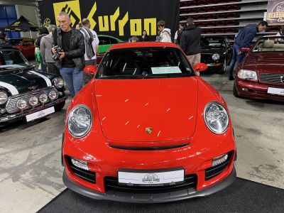 Front view of red Porsche 911 (997) with round headlights and aerodynamic bumper