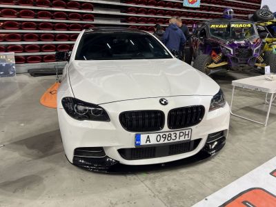 White sedan front view with black kidney grille and sporty bumper