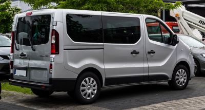 Silver passenger van rear and side profile with tinted windows and rear wiper