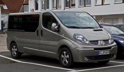 Silver passenger van with rounded headlights and large tinted side windows