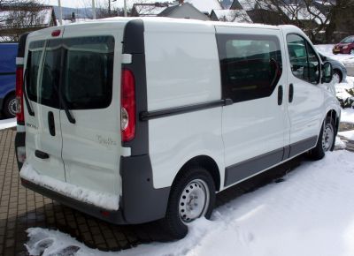 Rear and side view of white commercial van with sliding door